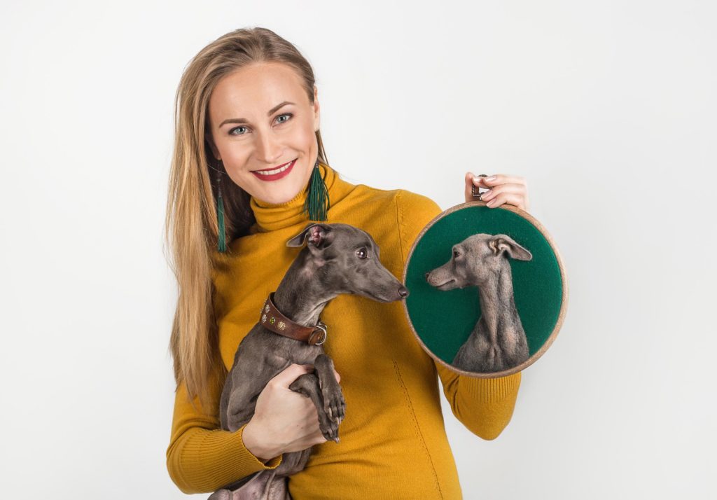 Artist Hanna Tsukanova demonstrates a 3D felt portrait of an Italian greyhound created by her and a dog that was a model